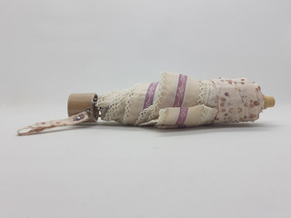 Beautiful Colorful Handheld Compact Small Female Cute Folded Umbrella Design for Rainy Season Protection in White Isolated Background