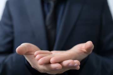 Fototapeta premium Businessman without head holding something without theme.