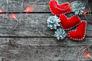 Christmas toy stockings, decorations and lights on a classic wooden table. Christmas holiday background with copy space.