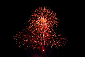 Red fireworks on black background.