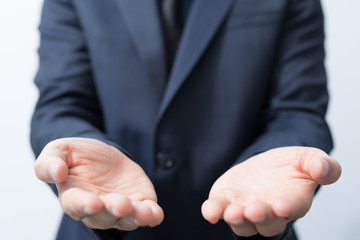 Fototapeta premium Businessman without head holding something without theme.