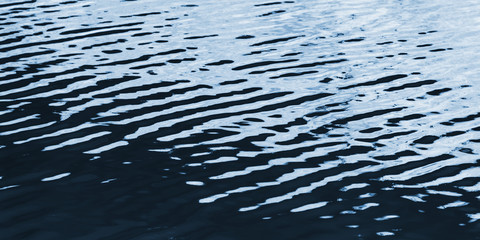 Dark blue water surface with ripple