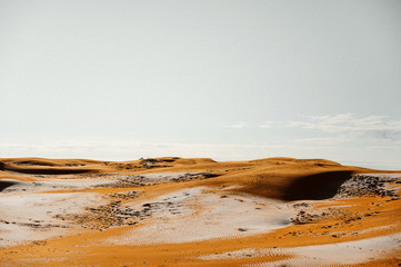 Desert with red sand and hoarfrost in winter