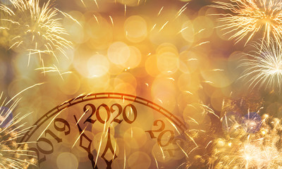 New Year clock near to the midnight of 2020, fireworks golden bokeh background