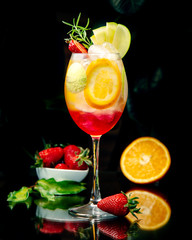 tropical juice with multiple sliced fruits