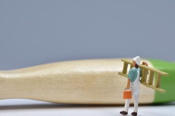 tiny painters are painting. Standing on a ladder, walking around brushes