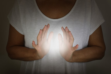 Healer demonstrating how to sense the human electromagnetic with hands - concept - woman in a white...