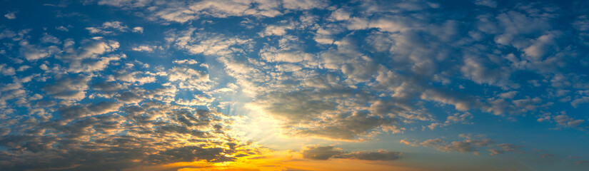 Naklejka na ściany i meble Panorama Sunset with clouds, in orange and colorful shades,World Environment Day concept: Fiery orange sunset sky with dark clouds.
