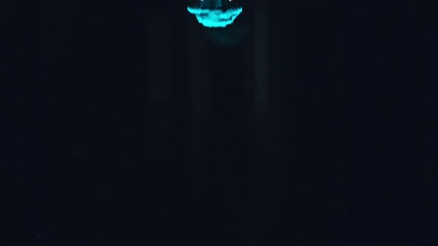 Paint fall into water which is twist. Spin acrylic ink drip into liquid. Visual effect bullet time, frozen moment, flow motion. Cloud fraction of color is spray drop. Slow motion cosmic video magic.