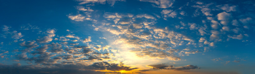 Panorama Sunset with clouds, in orange and colorful shades,World Environment Day concept: Fiery orange sunset sky with dark clouds.