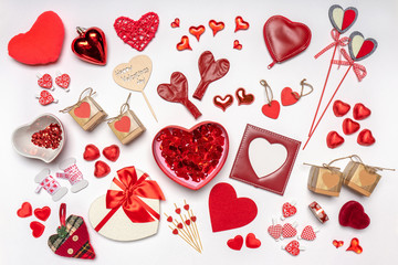 Various hearts and stylish accessories in heart shape, gifts and sweets in red color on white background. Empty photoframe, mock up. Greeting card for Valentine's day, love and romance concept