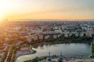 Big city aerial shot. Long and wide streets filled with cars. Shooting in the evening with the setting sun.