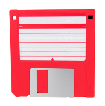 Red 3.5 inch compact floppy disk with blank label isolated on a white background