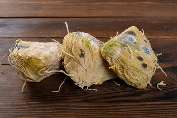 moldy noodles on a wood table
