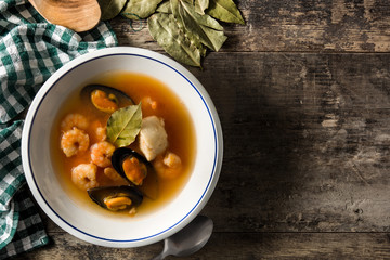French bouillabaisse soup on wooden table. Top view.Copy space	