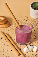 Pink berry smoothie with bamboo straw