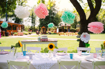 A table set for kids birthday party outdoors in garden in summer.
