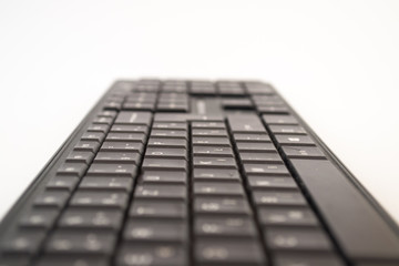 Black keyboard against the white background. Letters and numbers