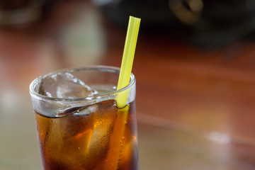 lass of cola with ice with copy-space in composition.Ice soda glass.refresh drink.Cola with crushed ice and straw in glass on white background.