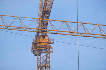 detail of building cranes with long arms at a construction site