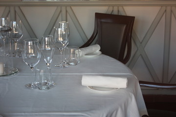 dining table set up and set up with a lot of elegance in the dining room of a restaurant or the dining room of a very rich house, in light white colors