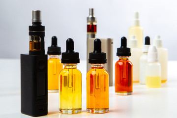 Vape. Vaper. Waping. Steam smoking equipment. Smoker Vape liquid with different tastes. Oil for vaping. Electronic cigarettes. Modern cigarettes. Juice bottles for vaping. Device for a vaper.