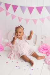 Fototapeta premium little girl black on white background. baby's first birthday