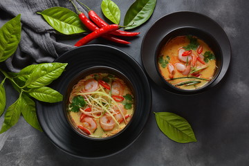 Laksa Soup – a Malaysian Coconut Curry Soup with shrimps over rice noodles topped with fresh bean spouts,cucumber, lime, red chili pepper and cilantro