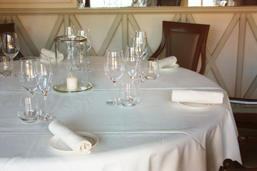 dining table set up and set up with a lot of elegance in the dining room of a restaurant or the dining room of a very rich house, in light white colors