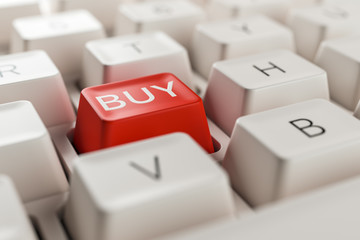 Macro view on retro pc keyboard with red buy key. Financial trading and online shopping concept.