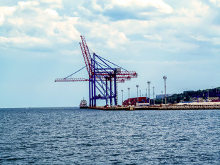 Red-blue Gantry cranes in the port of Odessa, Ukraine. Beautiful industrial seascape, view from the Black Sea