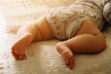 Obraz na płótnie Canvas Baby sleeping on her tummy. Naptime in child scheldue. Copy space