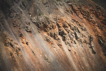 Nature background of big beautiful rocky mountain surface close-up. Natural backdrop of giant craggy mountainside with boulder stream. Textured plane of massive mountainous wall. Combe rock slopes. © Daniil
