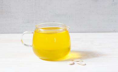 Pumpkin oil and seeds isolated on white background