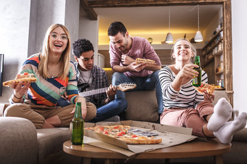 	Group best friends sitting at home watching a comedy movie .Watching tv show.	