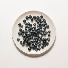 Blueberries on a white plate, top view