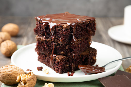 Delicious brownies with melted chocolate on a stack