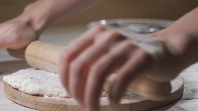 Making pizza or pide dough by close up male hands in pastry kitchen.