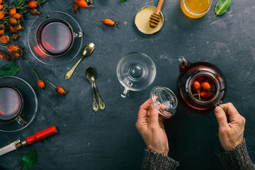 Woman is preparing tea from rose hips.