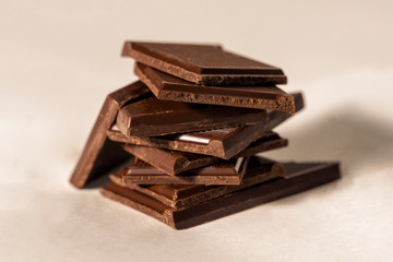 Broken dark chocolate piled turret tile. Sweet life