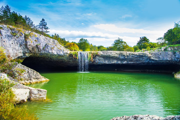 Fototapeta na wymiar Beautiful small waterfall Zarecki Krov on Pazincica River near Pazin in Istria, Croatia