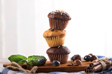 Blueberry and chocolate muffins on white wooden background