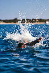 Swimmer training on the open sea / ocean.