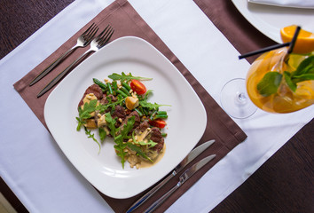beef tenderloin garnished with green beans and cherry tomatoes