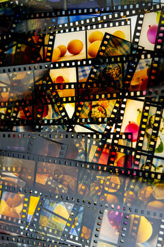 Developed color slide films lie on a light table.