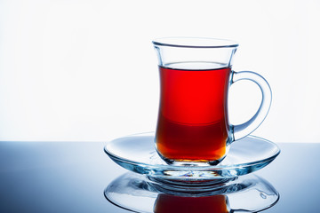Glass cup of hot aromatic tea on white background. Close up.