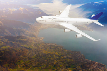 Fototapeta premium Airplane flying above clouds during sunset