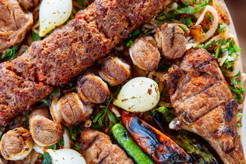 Traditional Turkish Adana kebab or kebap meat food, appetizers, raki and salgam on table from top view in turkish restaurant.	