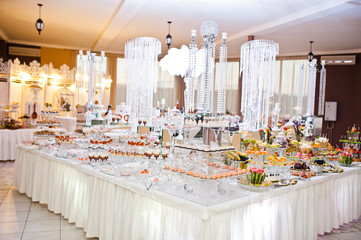 Dessert table of delicious sweets on wedding reception.