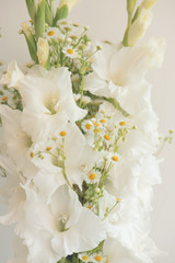 Obraz na płótnie Canvas Bouquet of white gladioli. Whiteness delicate gladiolus flowers. Close up, white background